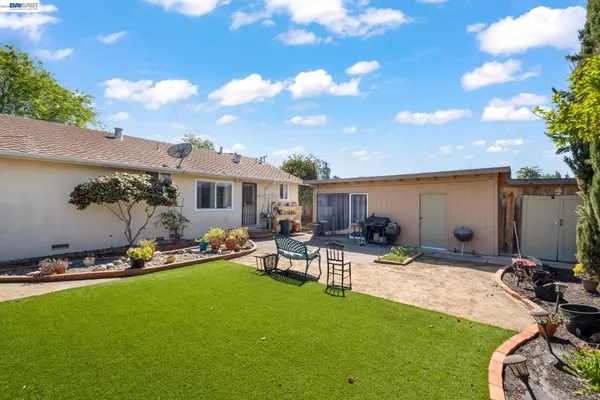 a view of a backyard with furniture
