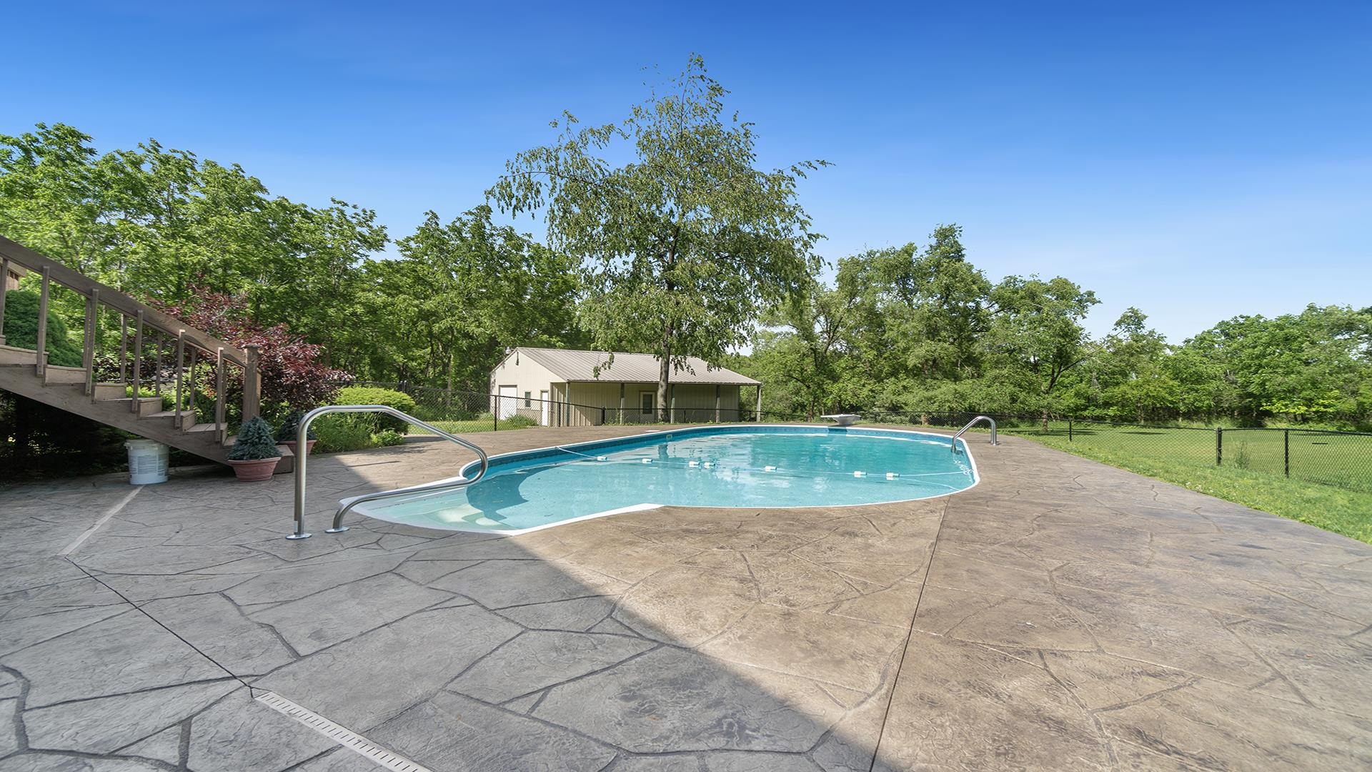 16405 Cannell Road Rockton, IL 61072 - Photo 46 of 53 a view of a swimming pool with a patio and a yard