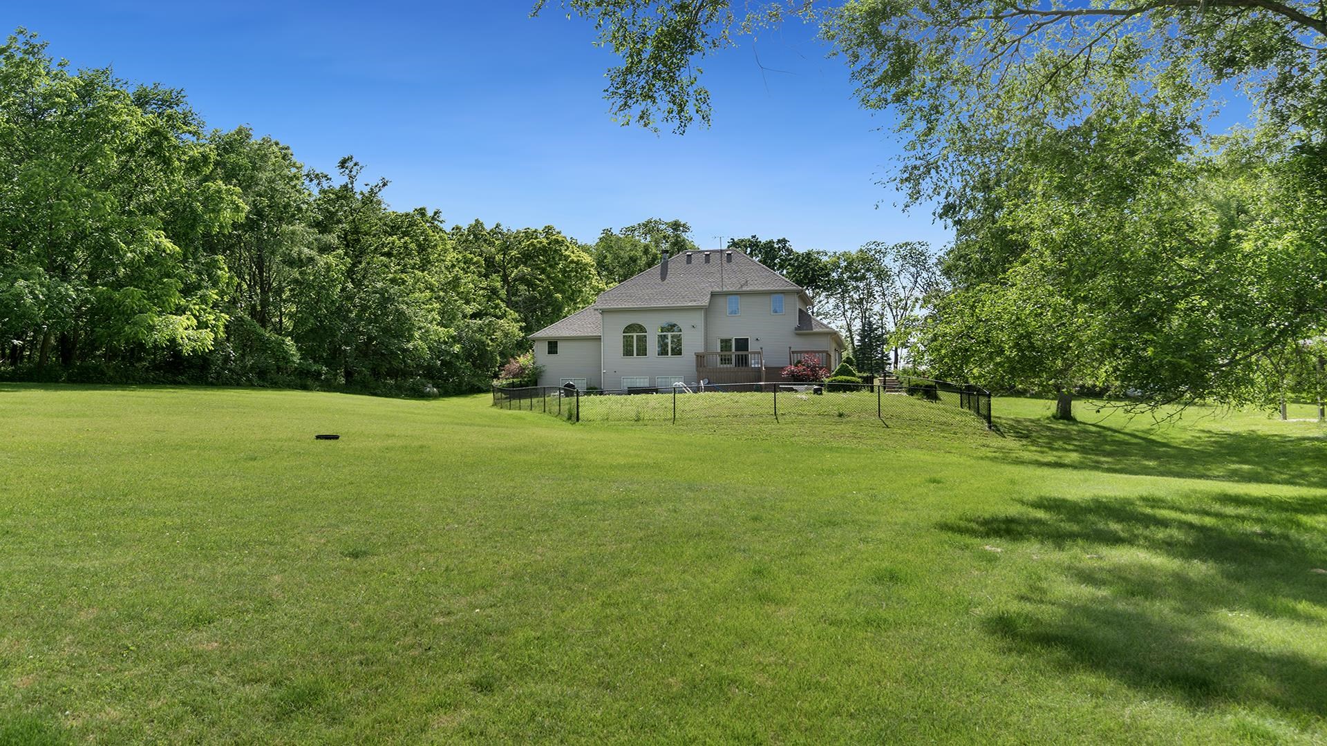 16405 Cannell Road Rockton, IL 61072 - Photo 49 of 53 a view of a big house with a big yard and palm trees