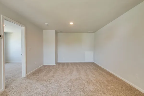 a view of an empty room and a window