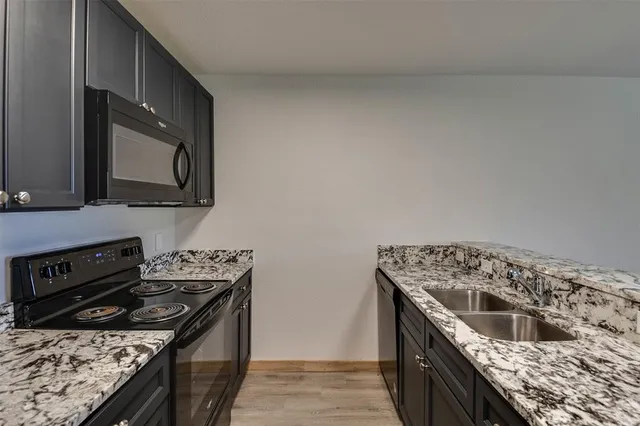 a kitchen with a stove and a sink