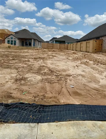 a view of a garden with a tree in the background