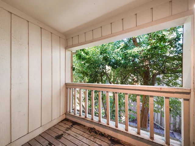a view of a porch with wooden floor