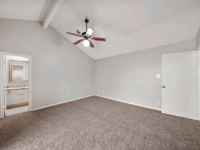 a view of an empty room with a fan