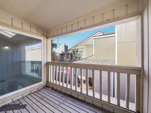a view of a porch with wooden floor