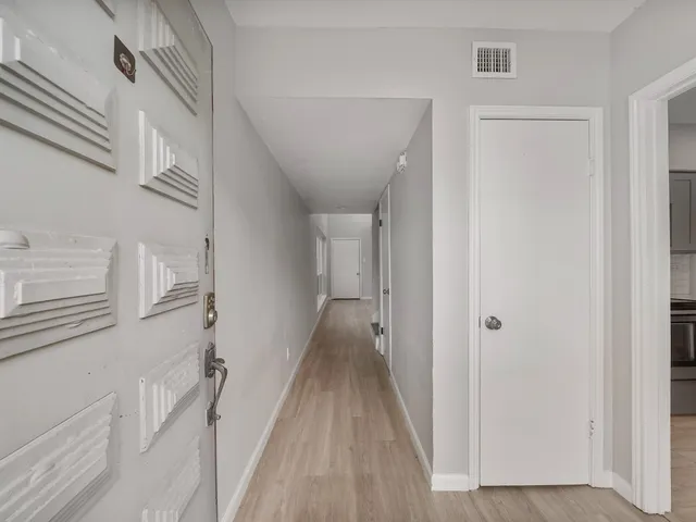 a view of a hallway with a white walls