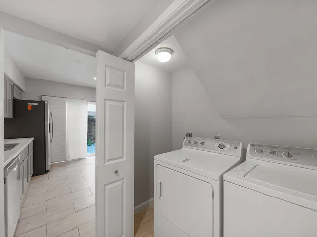 a view of storage and utility room with washer and dryer
