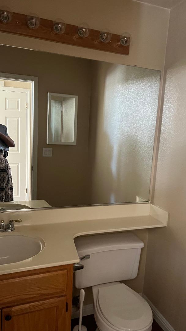 4259 Merced Circle Antioch, CA 94531 - Photo 15 of 21 a bathroom with a toilet a sink and a mirror