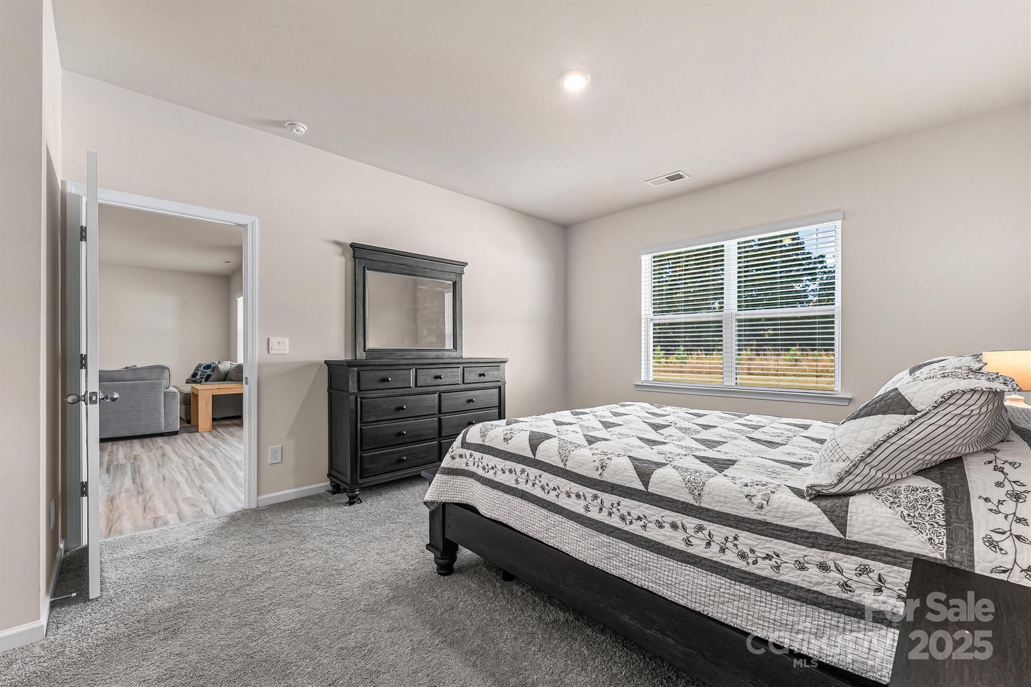 1219 Rutherford Street York, SC 29745 - Photo 14 of 38 a bed sitting in a spacious bedroom next to a window
