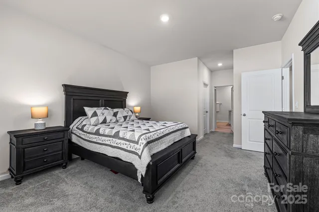 a bedroom with a bed and a mirror on dresser