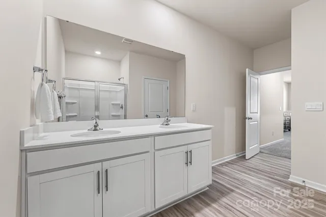 a bathroom with a double vanity sink and a mirror