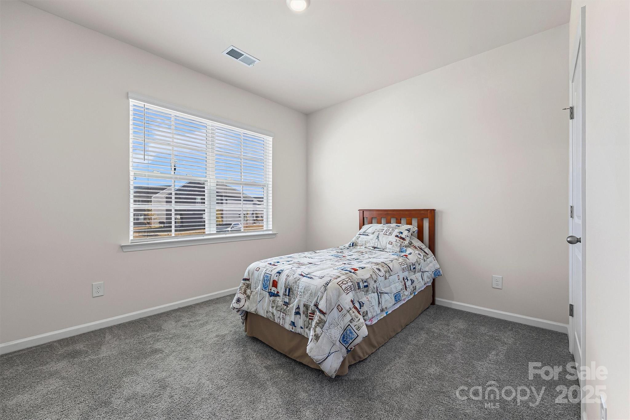 1219 Rutherford Street York, SC 29745 - Photo 19 of 38 a bed sitting in a bedroom next to a window