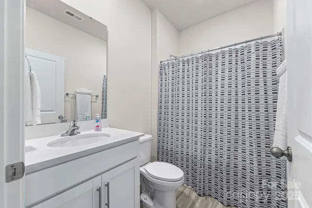 a bathroom with a sink toilet and mirror