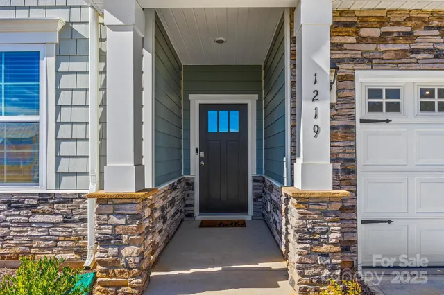 a balcony with a bench and shower