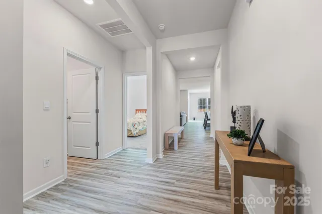 a view of a livingroom with wooden floor and furniture