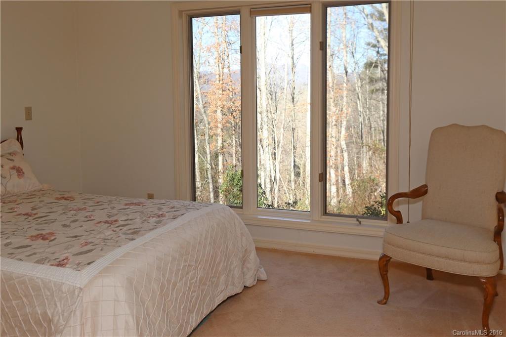 435 Clemson Road Waynesville, NC 28786 - Photo 17 of 21 a spacious bedroom with a bed and a window