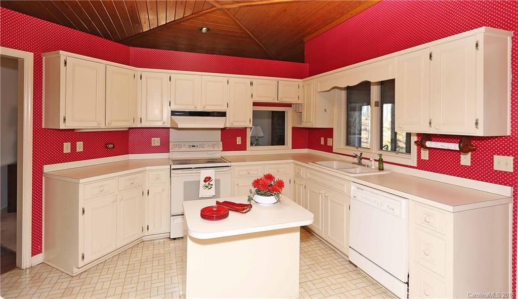 435 Clemson Road Waynesville, NC 28786 - Photo 6 of 21 a kitchen with a sink stove and white cabinets
