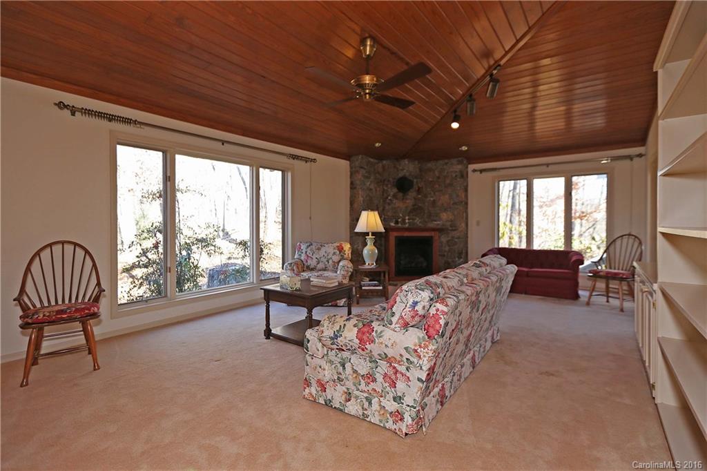 435 Clemson Road Waynesville, NC 28786 - Photo 7 of 21 a living room with furniture and a floor to ceiling window