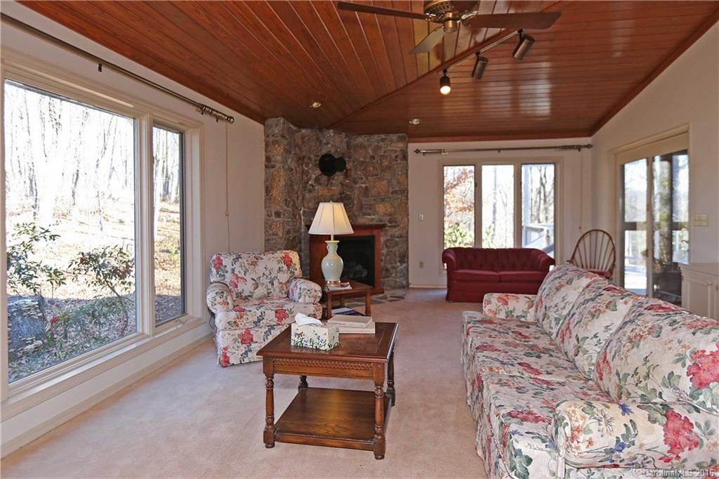 435 Clemson Road Waynesville, NC 28786 - Photo 9 of 21 a living room with furniture a chandelier and a large window