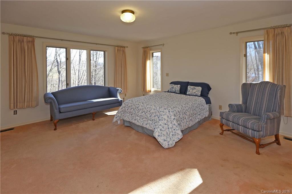 435 Clemson Road Waynesville, NC 28786 - Photo 10 of 21 a bedroom with a bed and a couch