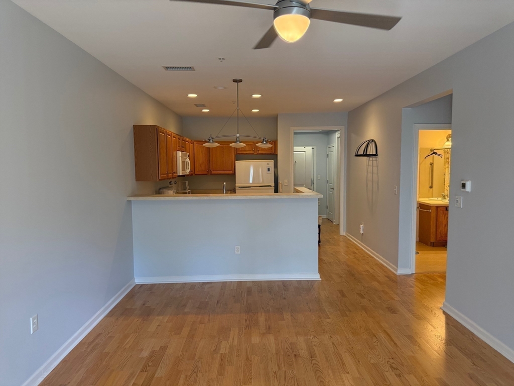 107 Clocktower Drive, Unit 207 Waltham, MA 02452 - Photo 1 of 18 a view of a kitchen with a sink and cabinets