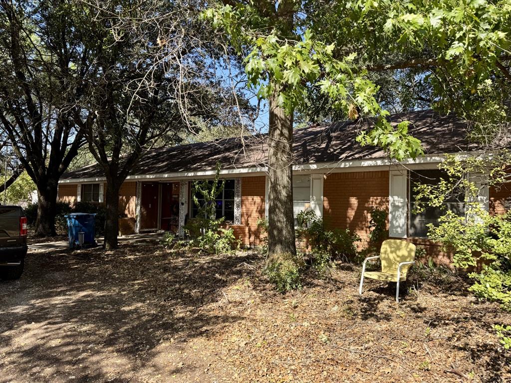 a couple of table and chairs in front of house