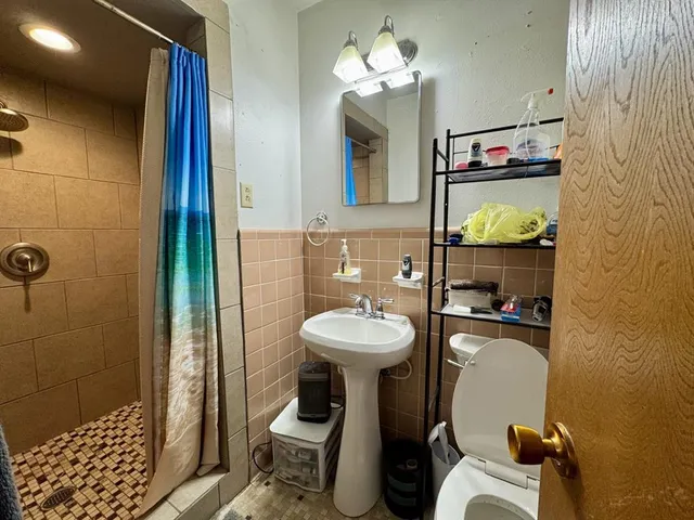 a bathroom with a sink toilet and shower