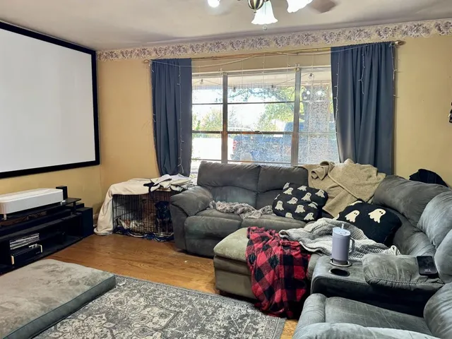 a living room with furniture window and a flat screen tv