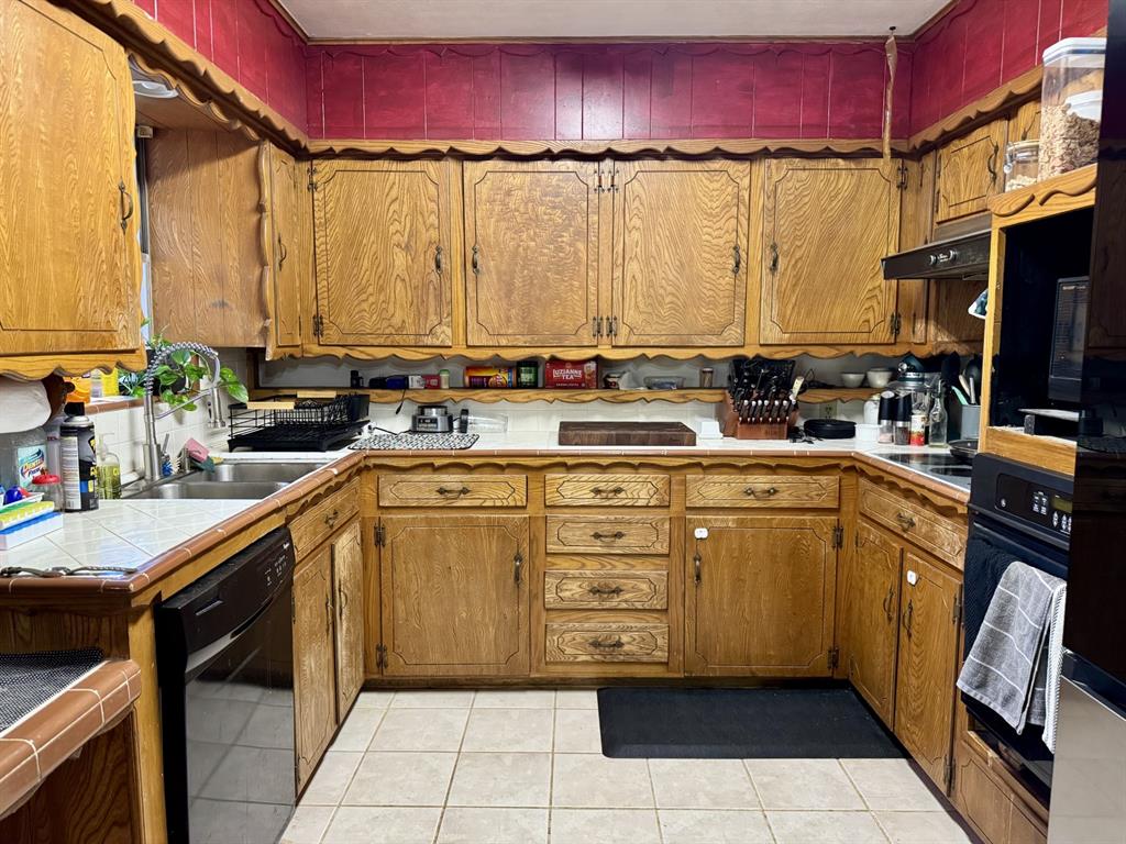 609 South Files Street Itasca, TX 76055 - Photo 7 of 29 a kitchen with a sink a stove and cabinets