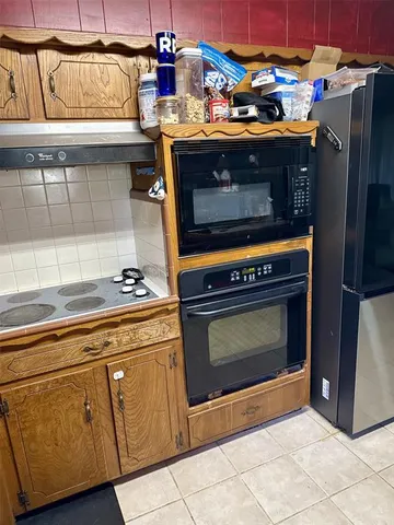 a stove top oven sitting inside of a kitchen