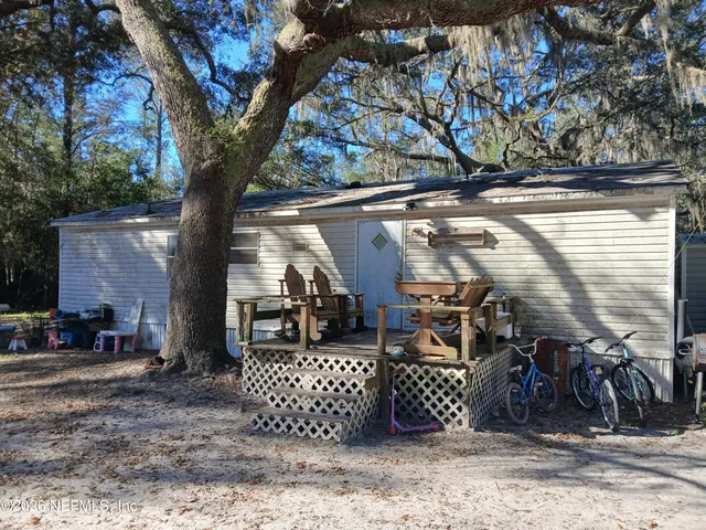 a view of a garage with wooden fence