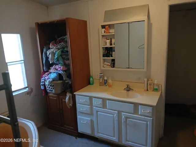 a bathroom with a sink and a mirror