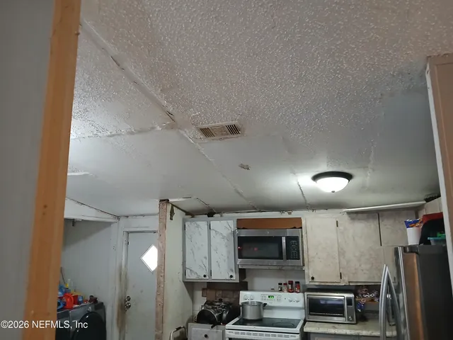 a kitchen with stainless steel appliances a refrigerator and a stove top oven