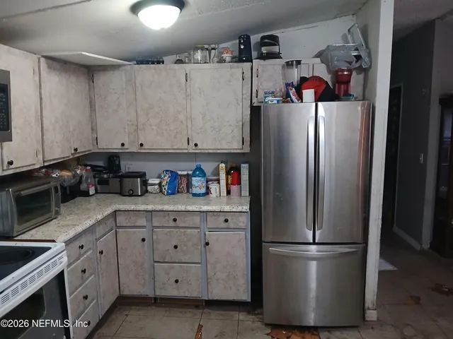 a white refrigerator freezer sitting in a kitchen