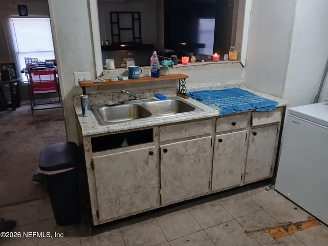 a kitchen with a sink and cabinets