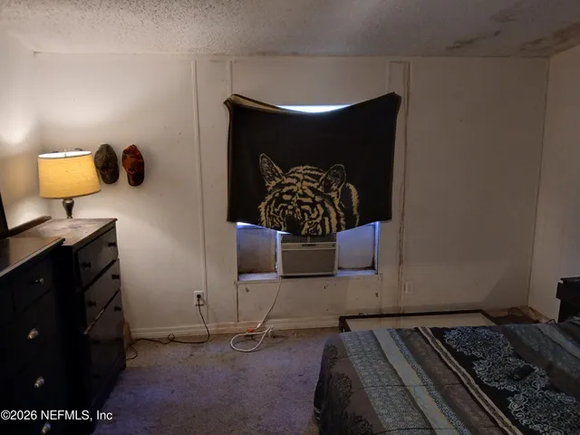 a bedroom with a bed and cabinets