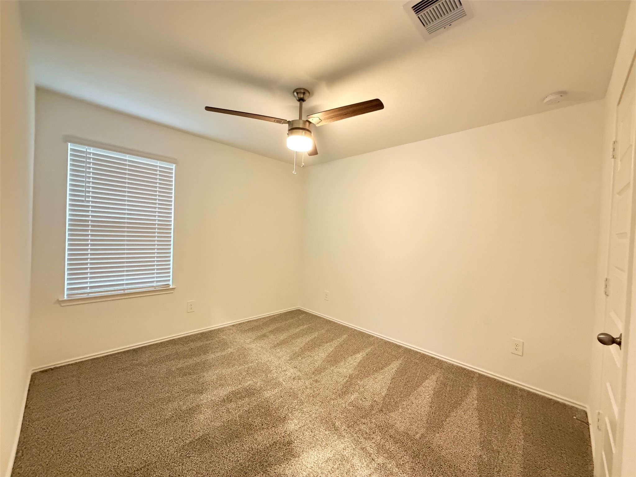 2913 Willow Gulch Way Rosenberg, TX 77469 - Photo 11 of 16 an empty room with a ceiling fan and a window