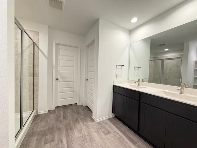 a spacious bathroom with a double vanity sink and a mirror
