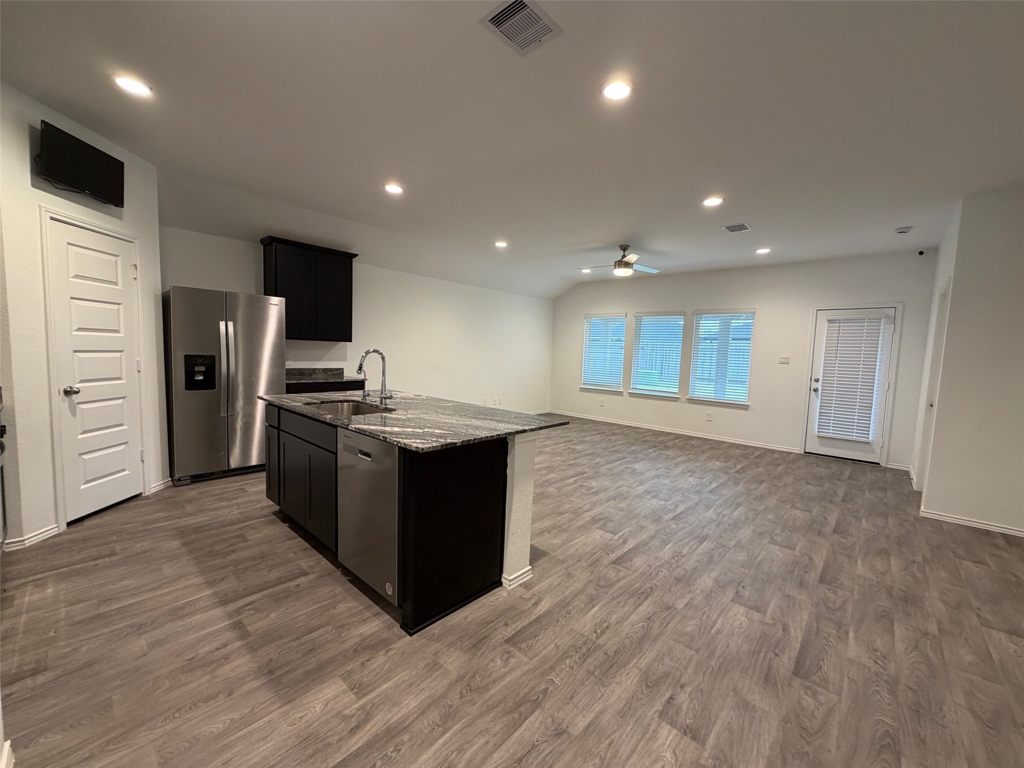 2913 Willow Gulch Way Rosenberg, TX 77469 - Photo 5 of 16 a kitchen with stainless steel appliances kitchen island granite countertop a stove and a refrigerator