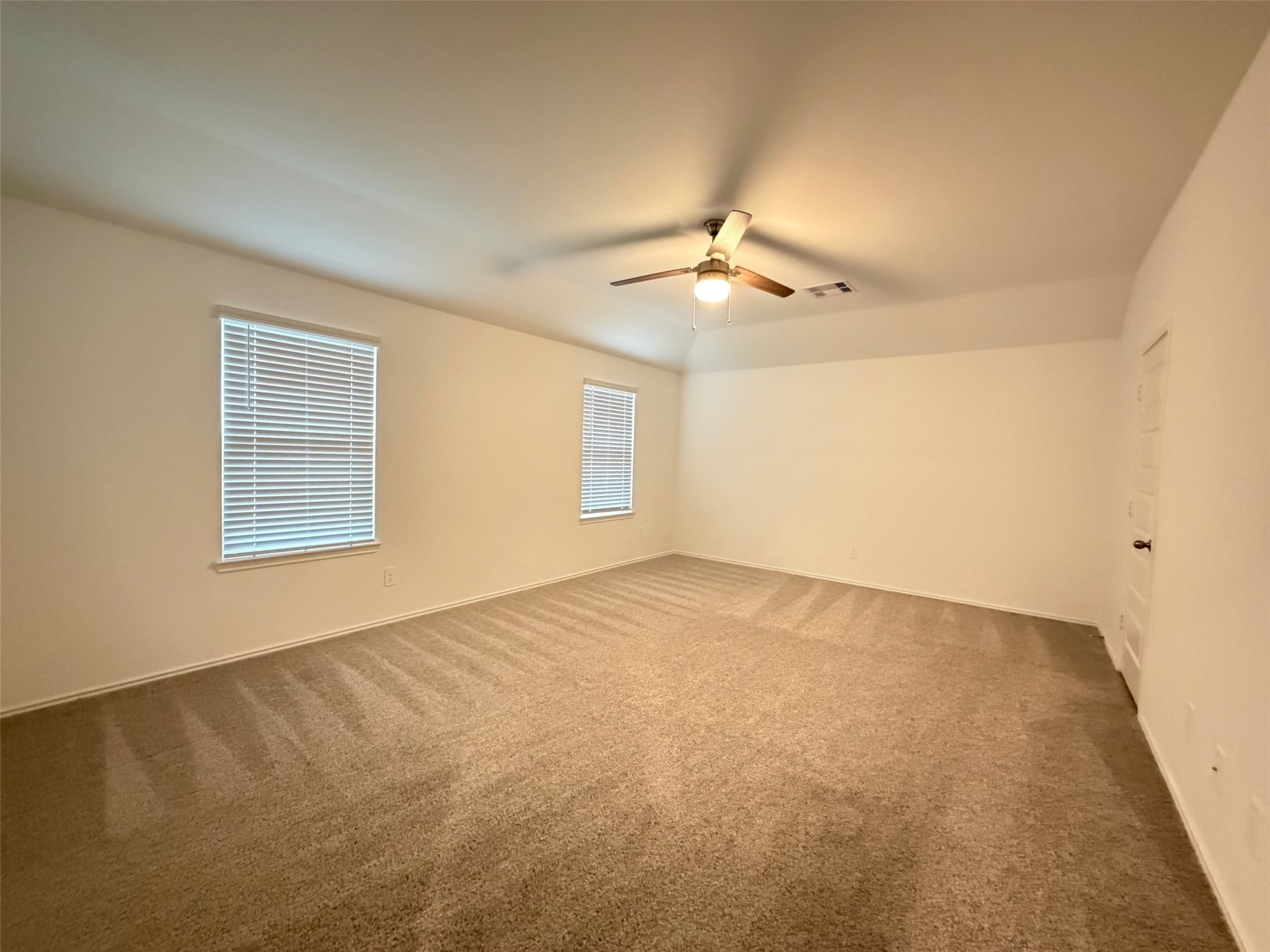 2913 Willow Gulch Way Rosenberg, TX 77469 - Photo 9 of 16 an empty room with windows and fan