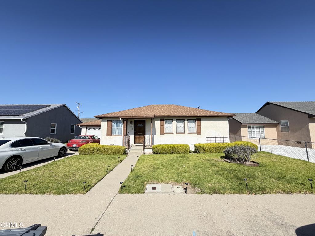 225 West Iris Street Oxnard, CA 93033 - Photo 1 of 1 a front view of a house with a yard