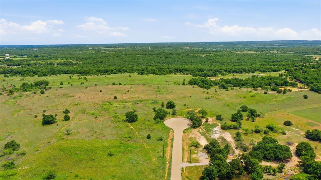 2051 Mustang Ridge Perrin, TX 76486 - Photo 3 of 25 a view of a lake with a building in the background