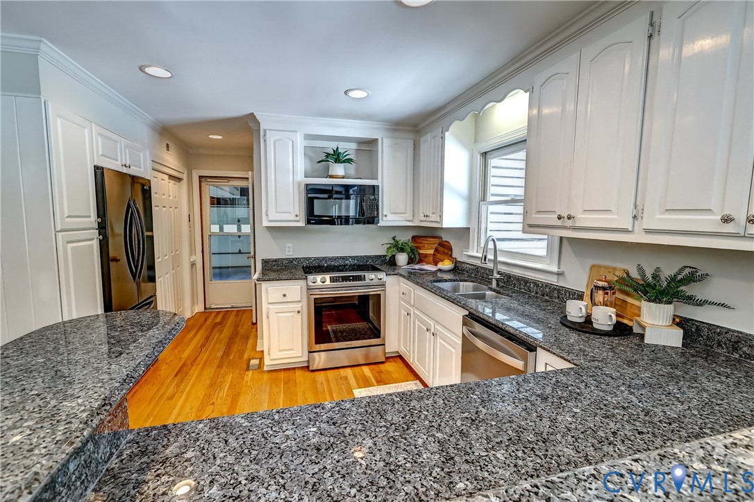 5201 Stone Horse Road Glen Allen, VA 23059 - Photo 14 of 54 a kitchen with stainless steel appliances granite countertop a sink stove and refrigerator