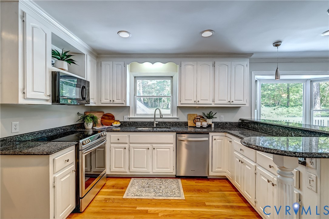 5201 Stone Horse Road Glen Allen, VA 23059 - Photo 16 of 54 a kitchen with granite countertop a stove sink and cabinets