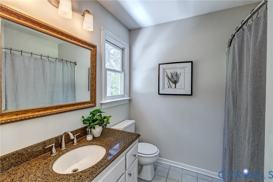 5201 Stone Horse Road Glen Allen, VA 23059 - Photo 26 of 54 a bathroom with a granite countertop toilet a sink and a mirror
