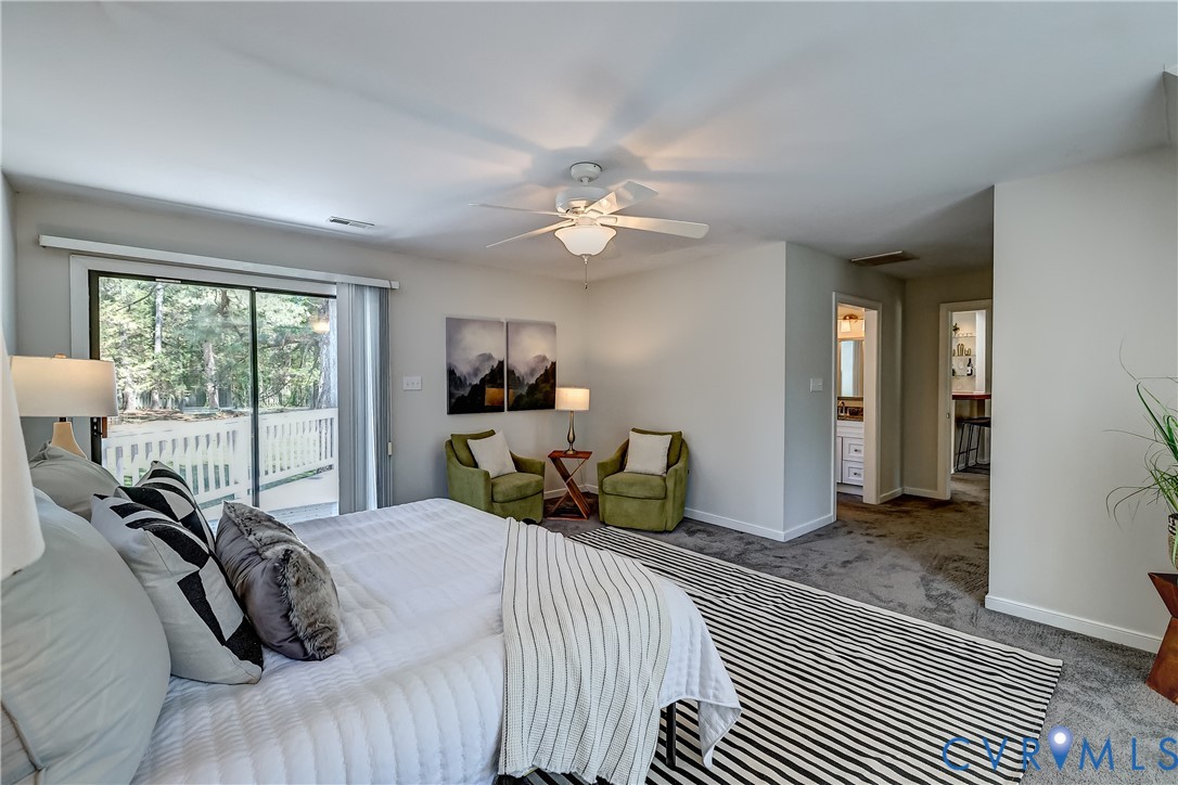 5201 Stone Horse Road Glen Allen, VA 23059 - Photo 30 of 54 a bedroom with a bed and a chandelier