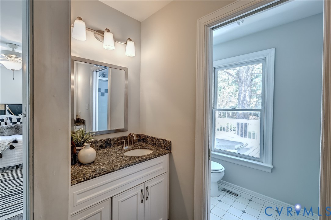 5201 Stone Horse Road Glen Allen, VA 23059 - Photo 31 of 54 a bathroom with a granite countertop sink and a mirror