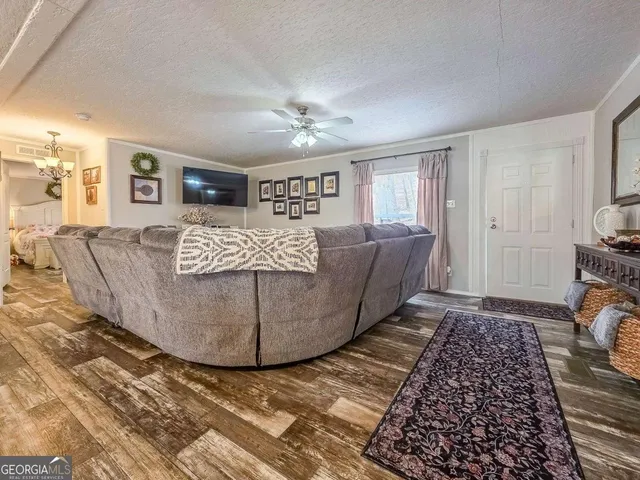 a living room with furniture a couch and dresser