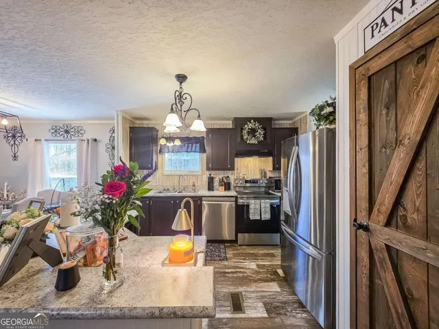 a view of a kitchen with furniture and a potted plant