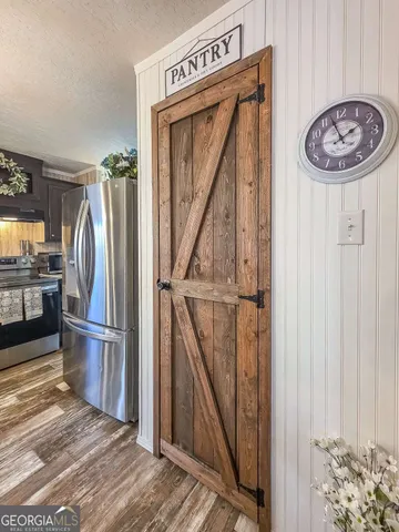a view of a kitchen with wooden floor and a kitchen
